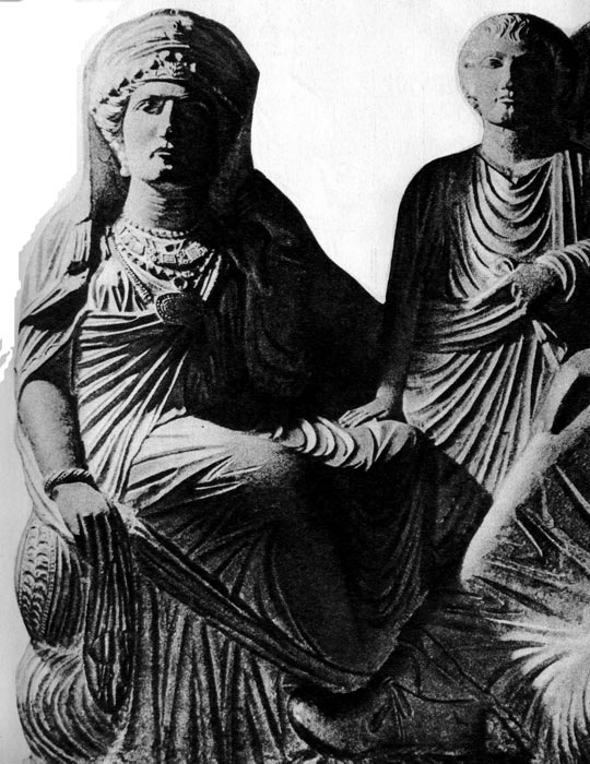 96. Надгробный рельеф из Пальмиры, II или III век н. э. Национальный музей, Дамаск. Надгробие представляет семью знатных римлян. Фигуры одеты в белые плащи, пал лы и тоги. На женщине богатые украшения: диадема, серьги, ожерелья, фибула, скрепляющая плащ, а на руках- перстни и браслет. 